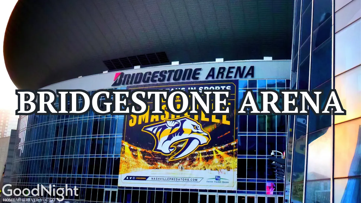 Exterior shot of the iconic Bridgestone Arena, featuring its recognizable signage, a large promotional banner, and a reflective glass facade. The scene buzzes with anticipation as crowds gather for events.